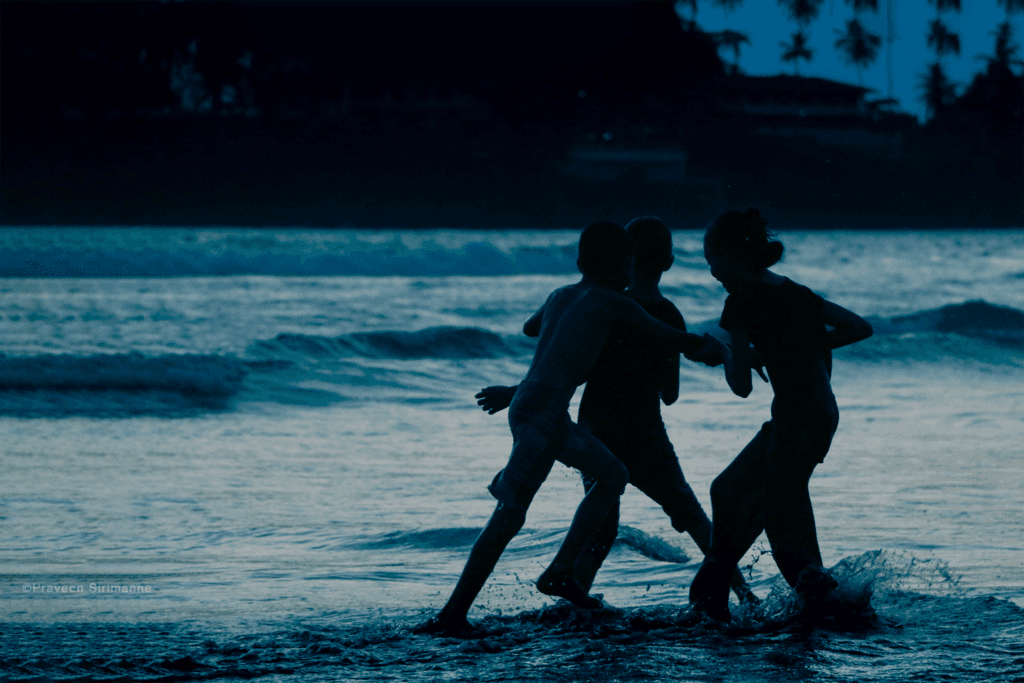 A bunch of Sri Lankan kinds playing in the beach